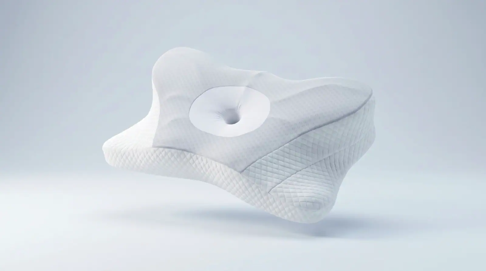The Cerivelle pillow floating in soft daylight: white quilted sides, a grey breathable top and a round head cradle
